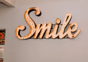 Illuminated 'Smile' sign inside LuxeSmile Dentistry